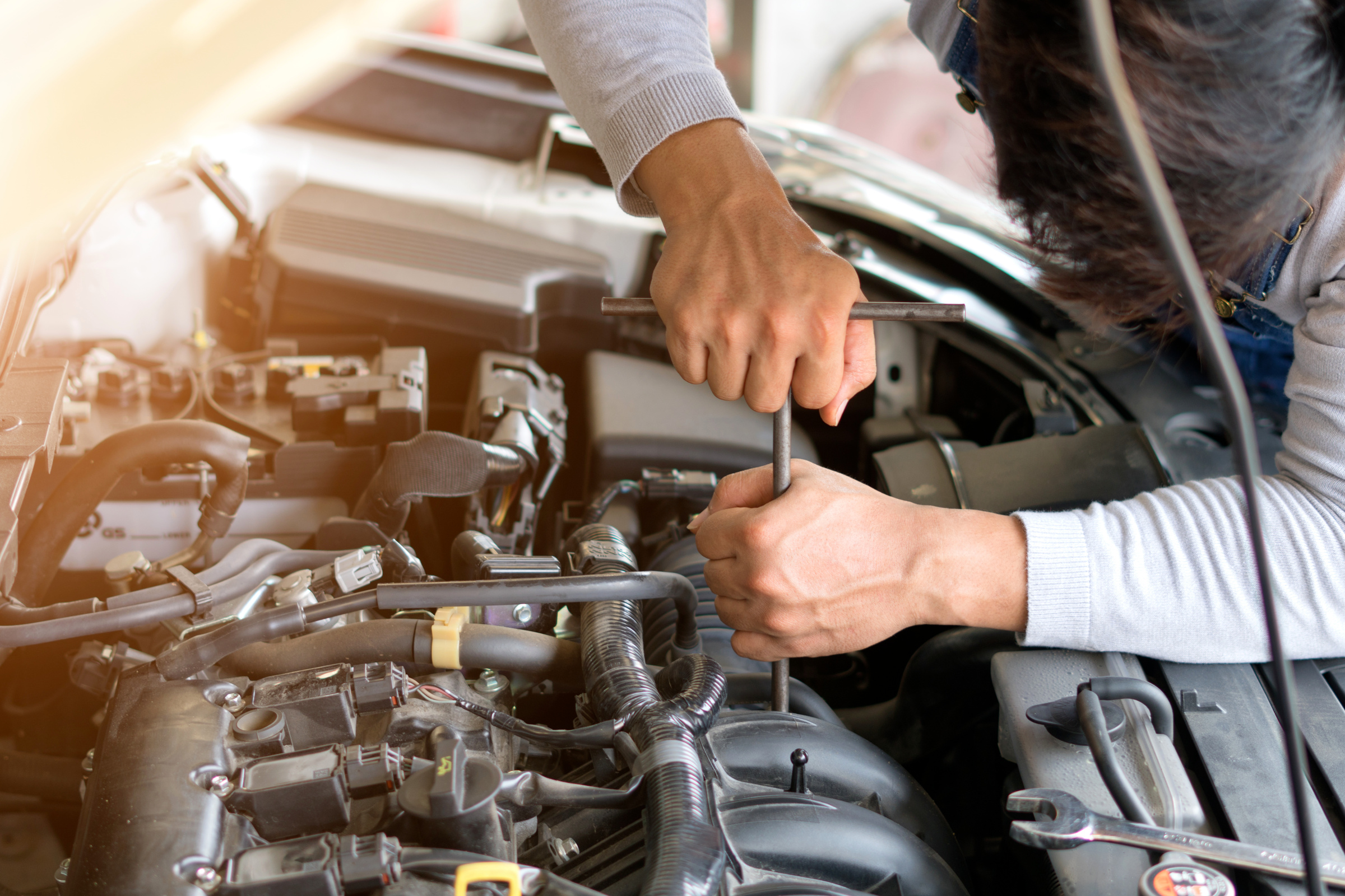 Auto mechanic working in garage. Repair service.